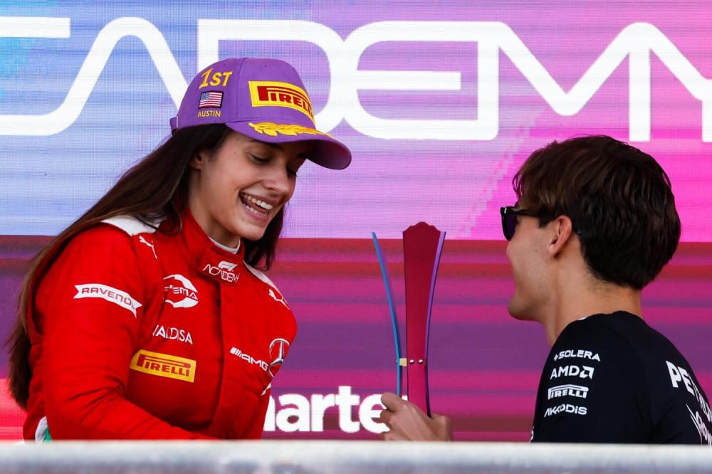 CIRCUIT OF THE AMERICAS, UNITED STATES OF AMERICA - OCTOBER 21: Marta Garcia celebrates winning the F1 Academy Championship on the podium with the trophy being presented by George Russell, Mercedes-AMG during the United States GP at Circuit of the Americas on Saturday October 21, 2023 in Austin, United States of America. (Photo by LAT Images)